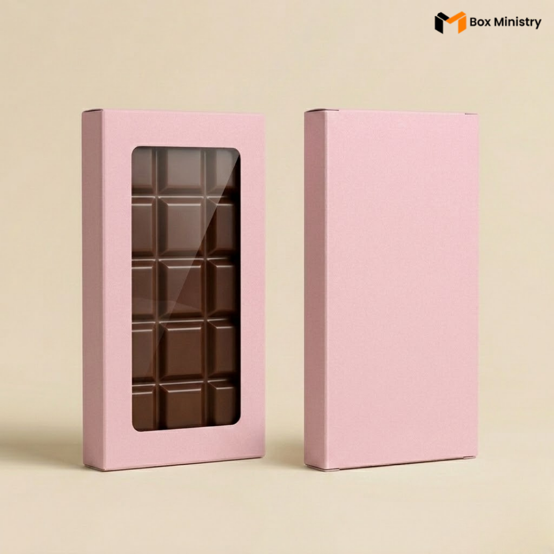 Pink chocolate box with a clear window showing chocolate bars on a beige background