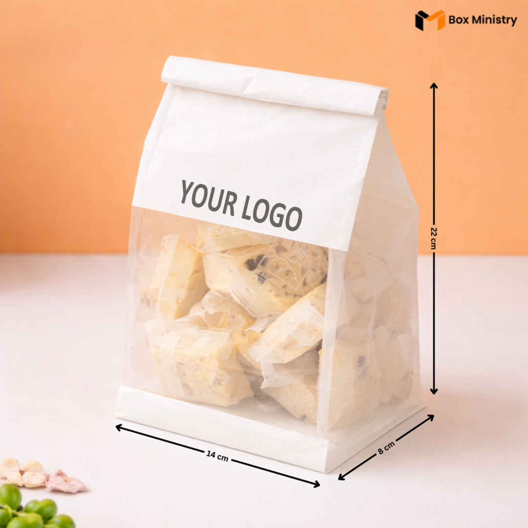 Clear packaging bag with a white label for branding, containing cookies, on an orange background.