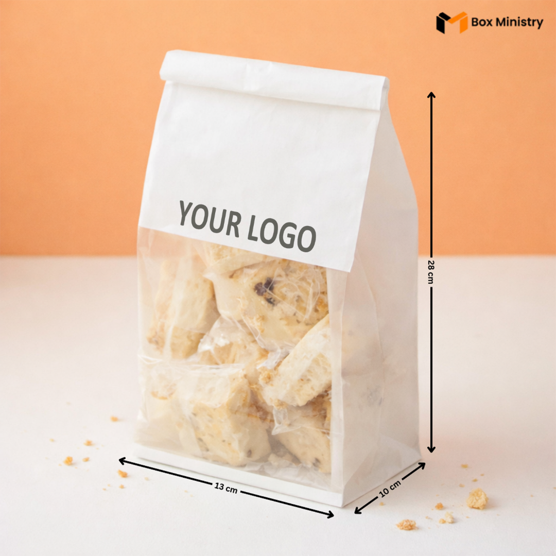 Clear packaging bag with cookies and a white label for branding, on an orange background.