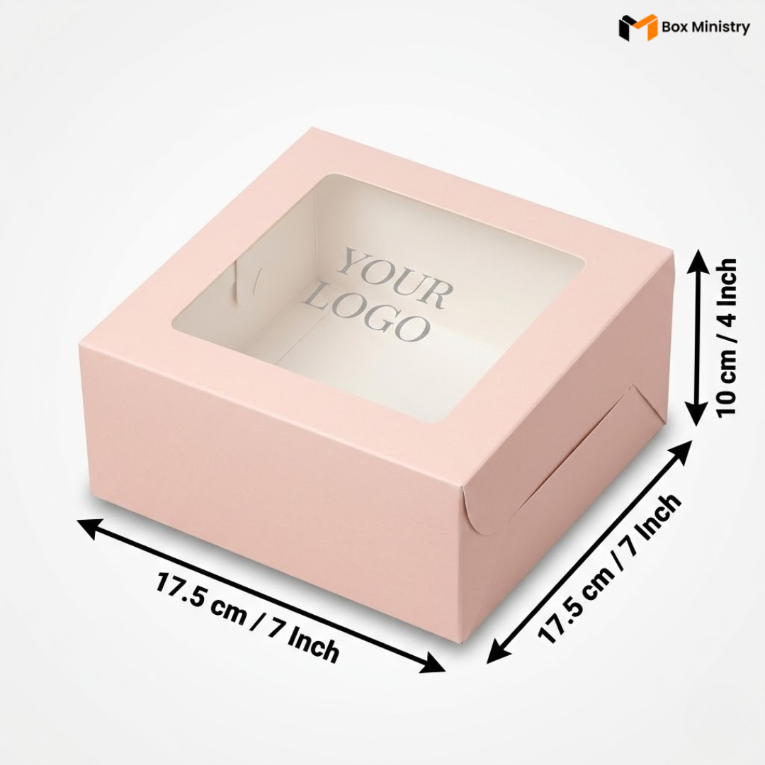 Soft blush pink square window cake box with clear PVC lid window showing "YOUR LOGO" text in elegant serif grey font on white interior, dimensions 17.5 x 17.5 x 10 cm (7 x 7 x 4 inches), shown in 3/4 isometric angle with bold black measurement arrows, visible tuck-lock flap on right side face, matte finish, on a soft light grey-white gradient background