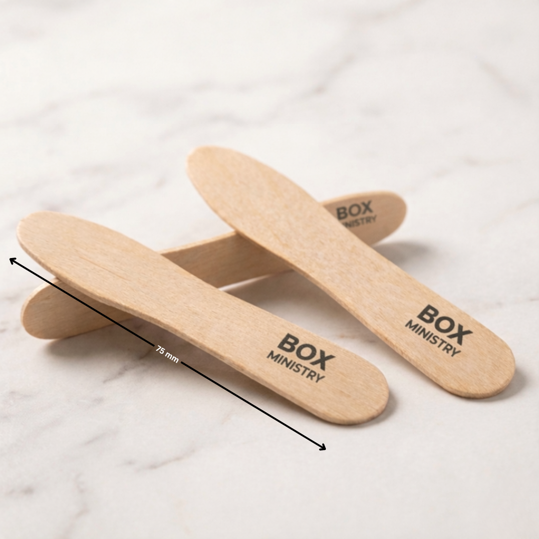 Wooden insoles with 'Box Ministry' branding on a marble surface