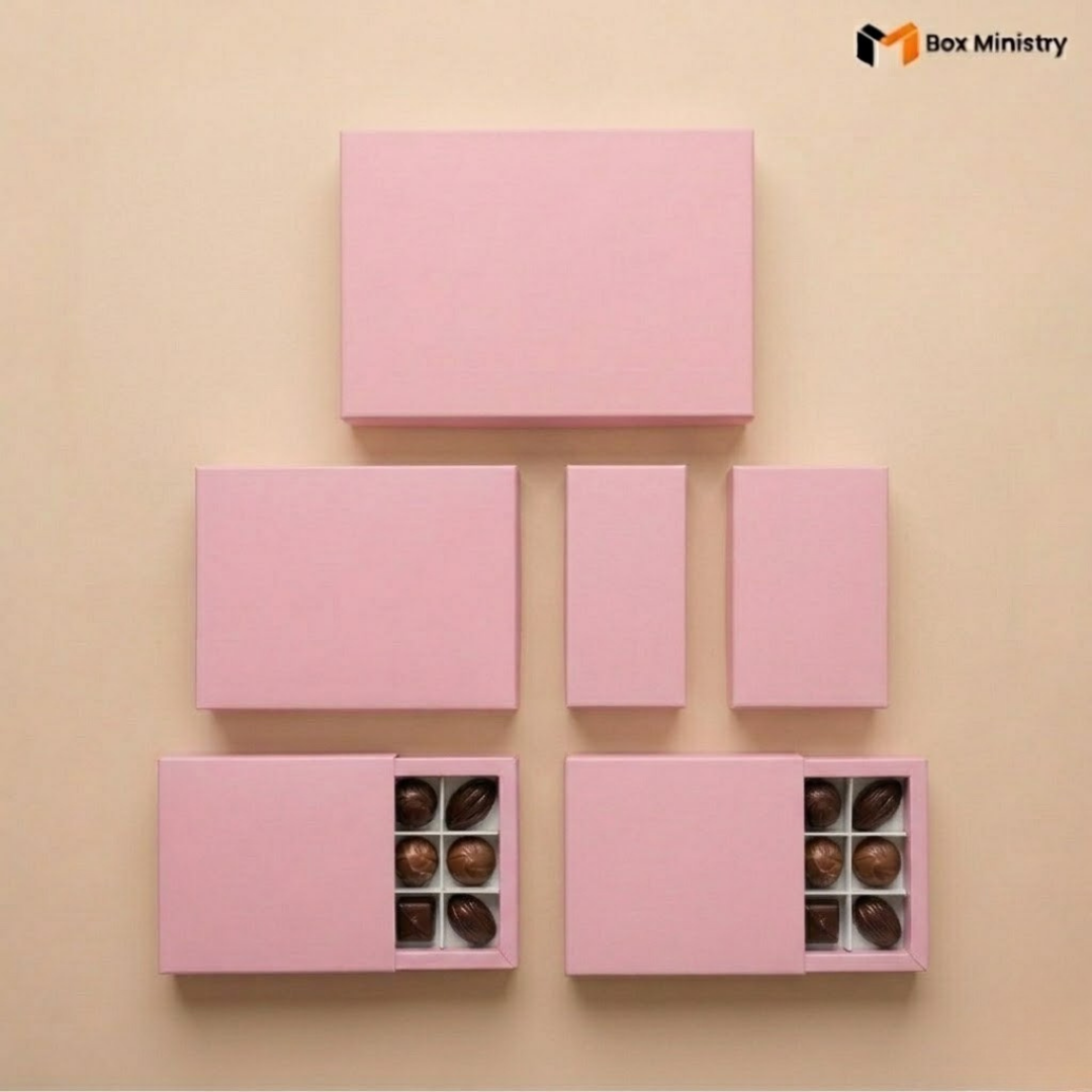 Set of pink chocolate boxes with visible chocolates on a beige background, featuring 'Box Ministry' logo.