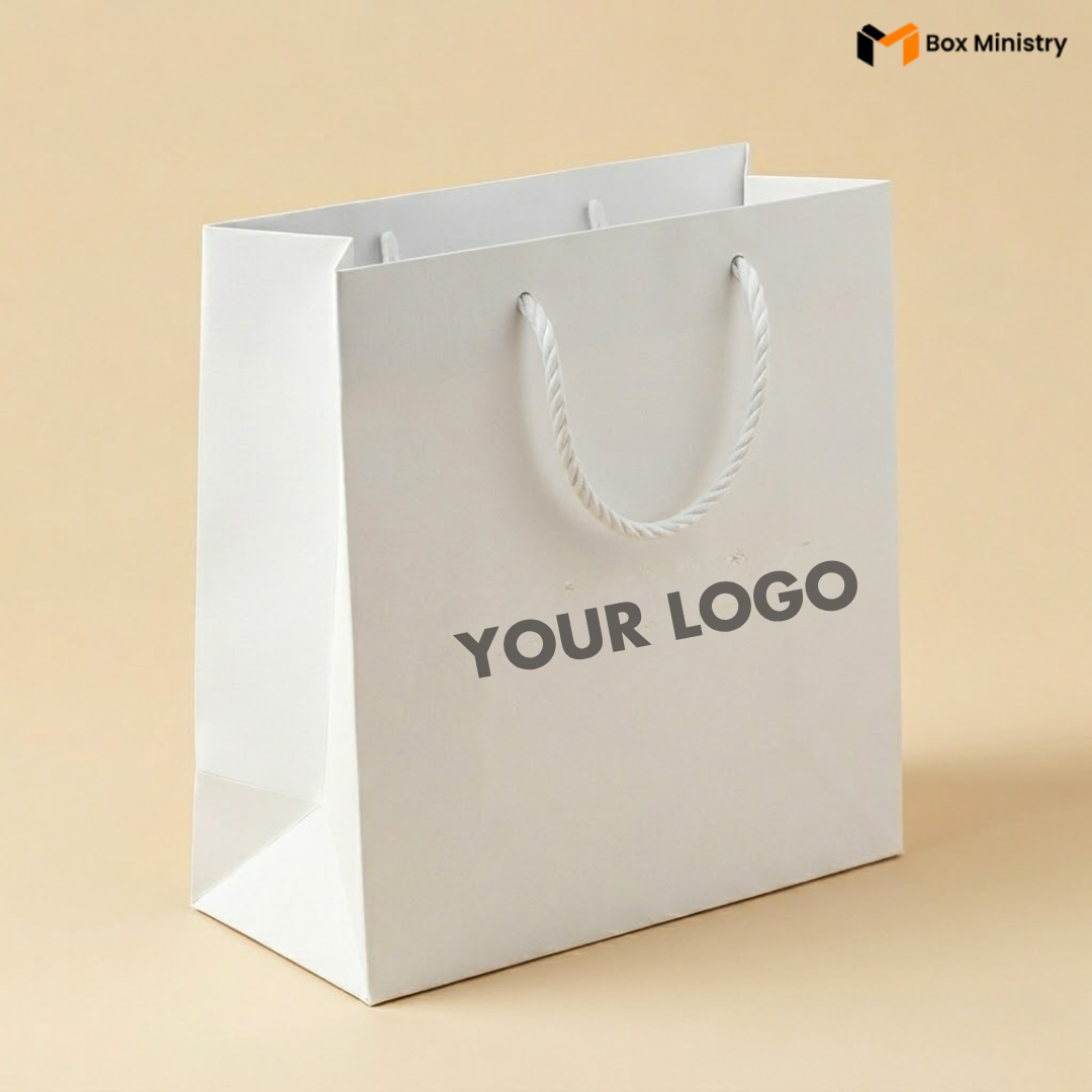White paper bag with 'YOUR LOGO' text on a beige background, featuring the Box Ministry logo.