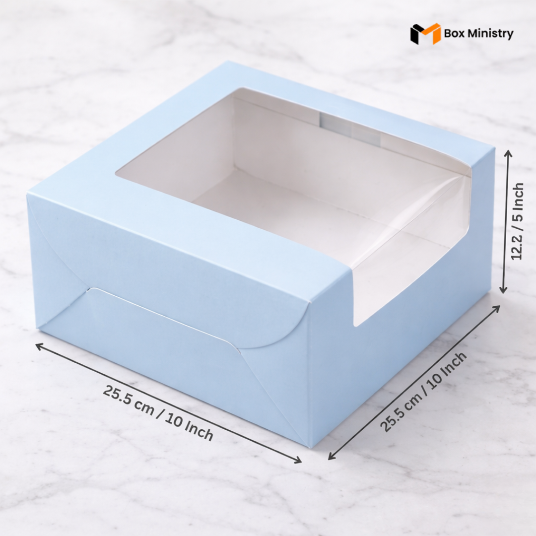 Pastel blue cake box 25.5x25.5x12.5cm with L-shape PVC window on white marble background