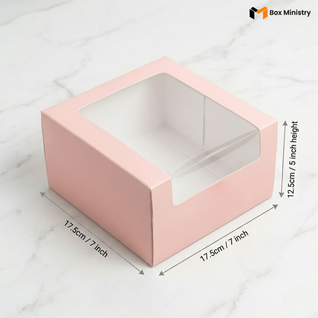 Pastel pink cake box 17.5x17.5x12.5cm with L-shape PVC window on white marble backgroundPastel pink cake box 25.5x25.5x12.5cm with L-shape PVC window on white marble background