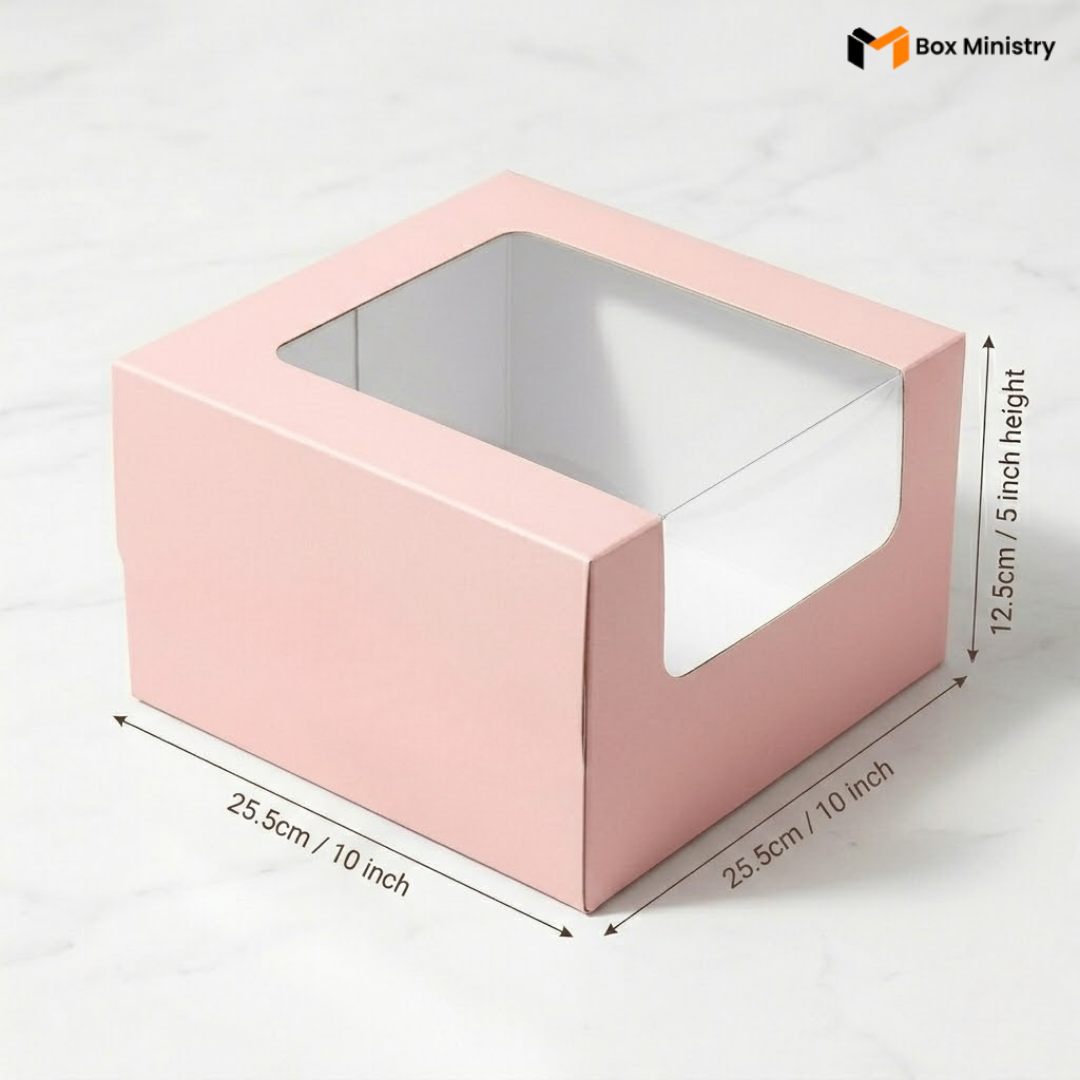 Pastel pink cake box 25.5x25.5x12.5cm with L-shape PVC window on white marble background