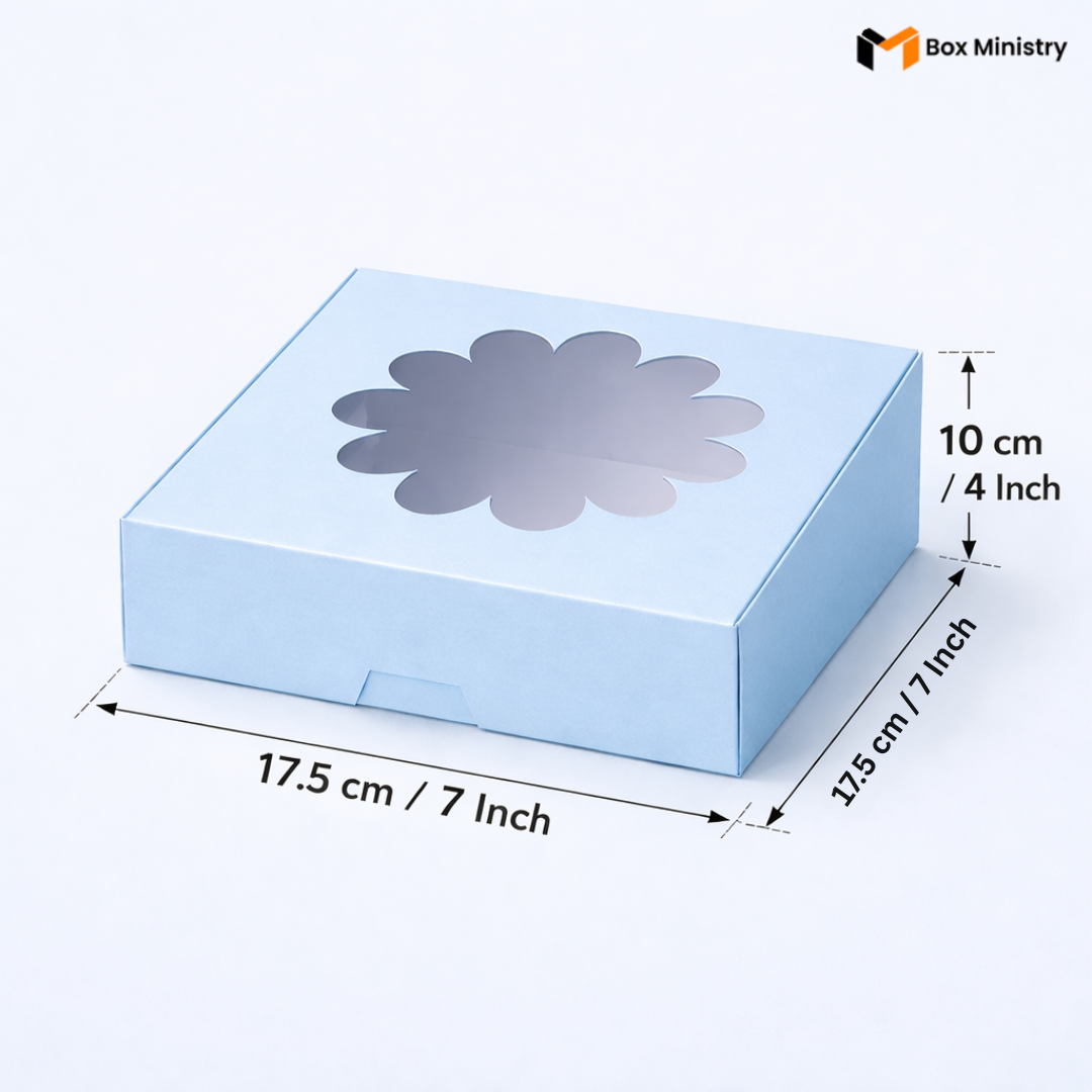 Sky blue flower window cake box 17.5x17.5x10 cm (7x7x4 inch) with decorative flower-shaped PVC window on top showing clear interior, dimensions labeled with measurement arrows on pale icy blue background — Blue Flower Window Cake Box .