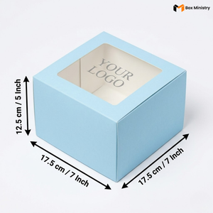Soft sky blue square cake box with large square clear PVC window on lid showing "YOUR LOGO" text in elegant serif grey font on white interior base, dimensions 17.5 x 17.5 x 12.5 cm (7 x 7 x 5 inches), shown in 3/4 isometric angle with bold black measurement arrows on left and bottom edges, visible tuck-lock flap on right side face, matte finish, on a soft pure white background
