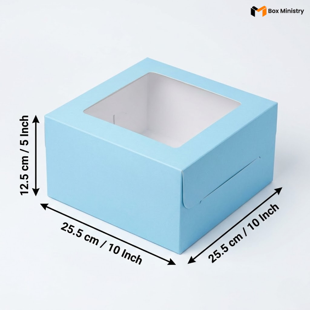 Sky blue square window cake box with clear PVC lid window, dimensions 25.5 x 25.5 x 12.5 cm (10 x 10 x 5 inches), shown in 3/4 isometric angle with measurement arrows, white interior lining visible through window, on a soft light grey-white background