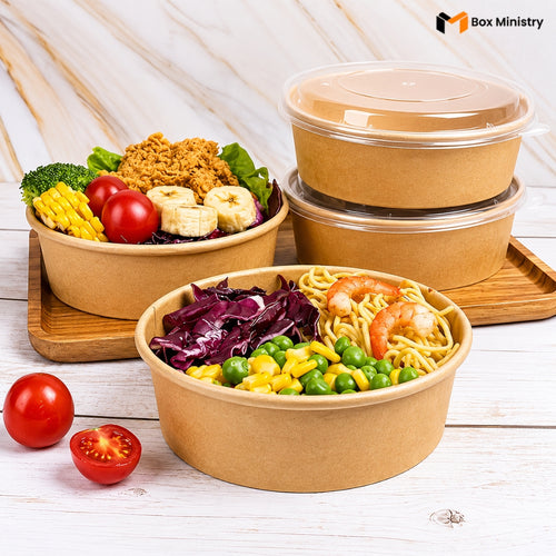Set of brown paper food containers with food and vegetables on a wooden surface, featuring 'Box Ministry' branding.