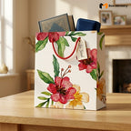 Floral gift bag with a tag on a wooden surface, featuring 'Box Ministry' logo.