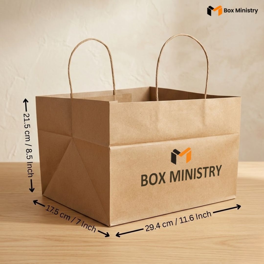 Brown paper bag with 'Box Ministry' branding and dimensions on a wooden surface.