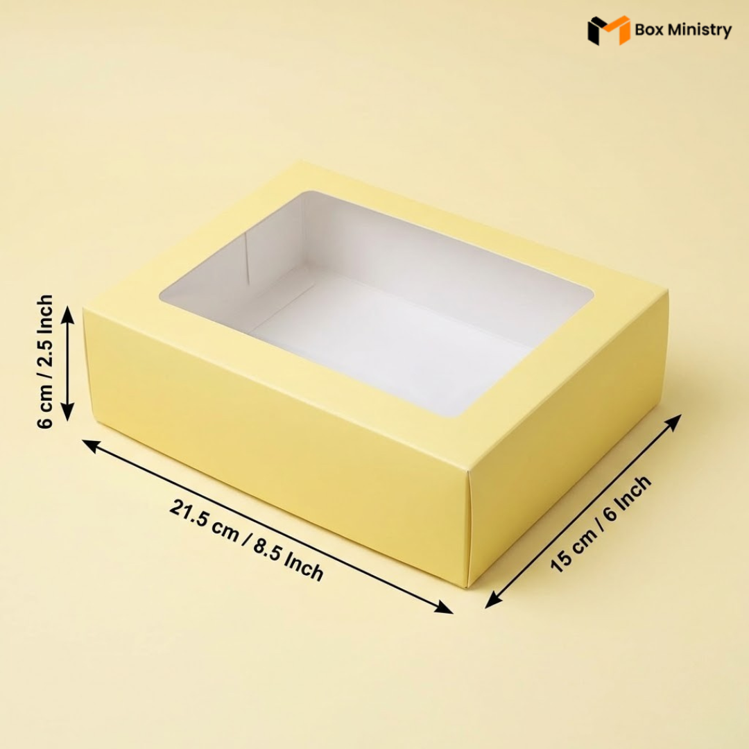 Yellow box with a clear window and measurements on a white background, featuring the Box Ministry logo.