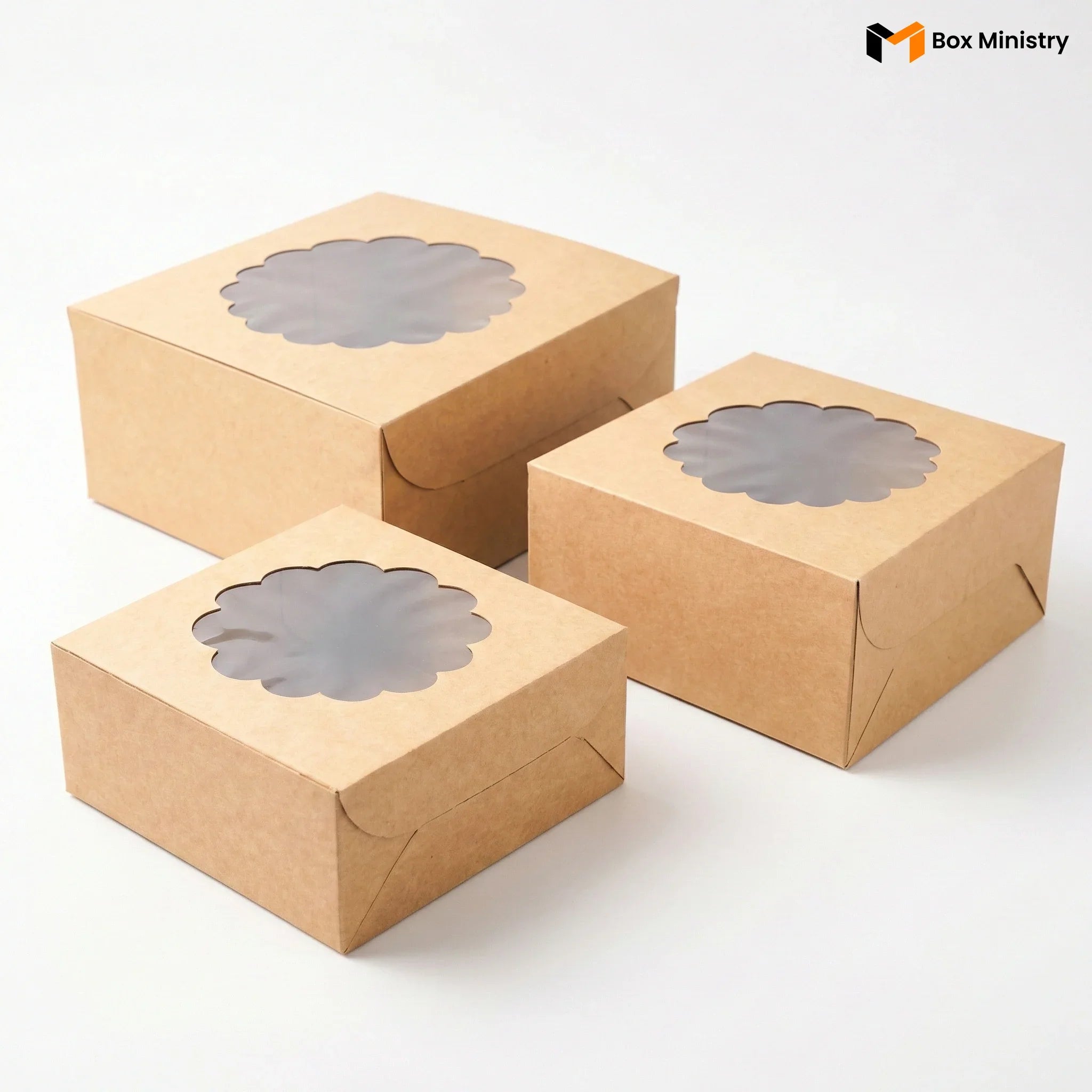 Three brown cardboard boxes with windowed tops on a white background, branded 'Box Ministry'.