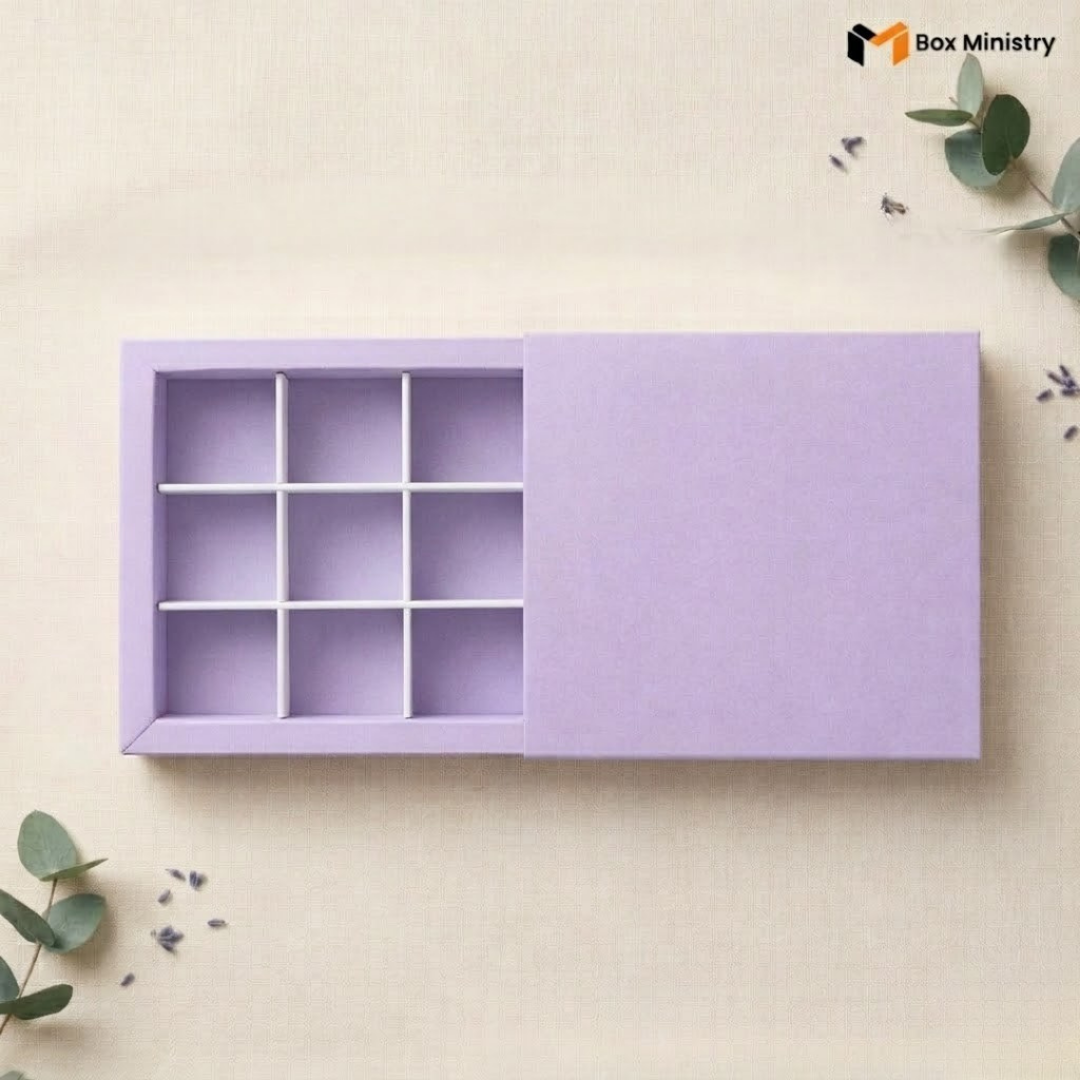 Purple jewelry box with compartments on a light beige background with green leaves.