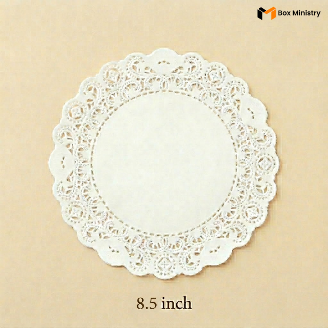 White paper doily with lace edge on a beige background, featuring 'Box Ministry' branding.