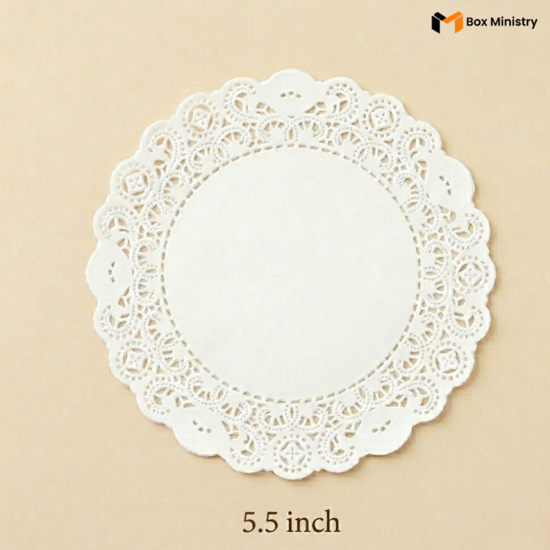 White paper doily with lace edge on a beige background, labeled '5.5 inch' and 'Box Ministry'.