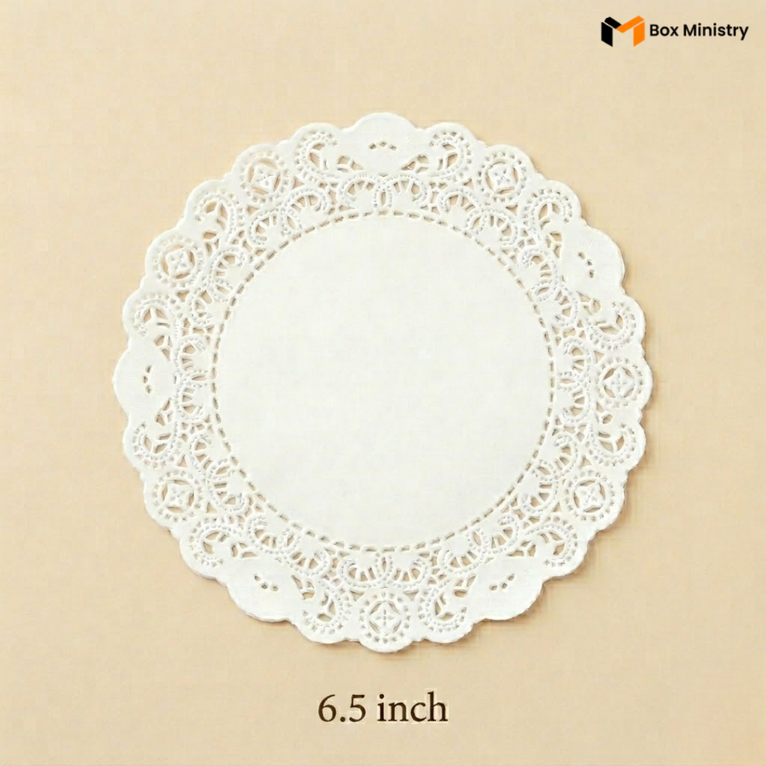White paper doily with lace edge on a beige background, featuring 'Box Ministry' branding.