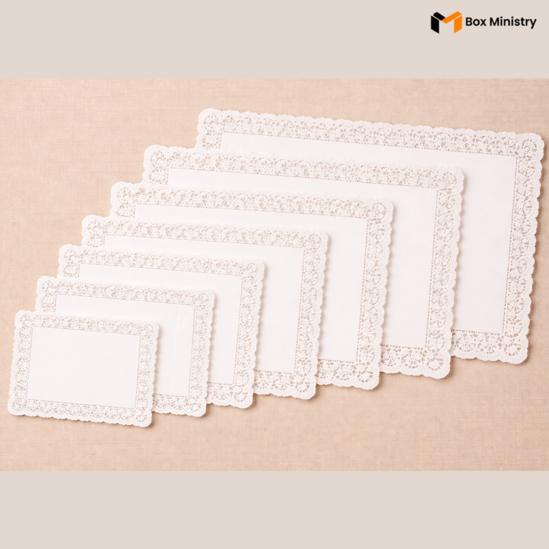 Set of white lace placemats on a beige background with 'Box Ministry' branding.