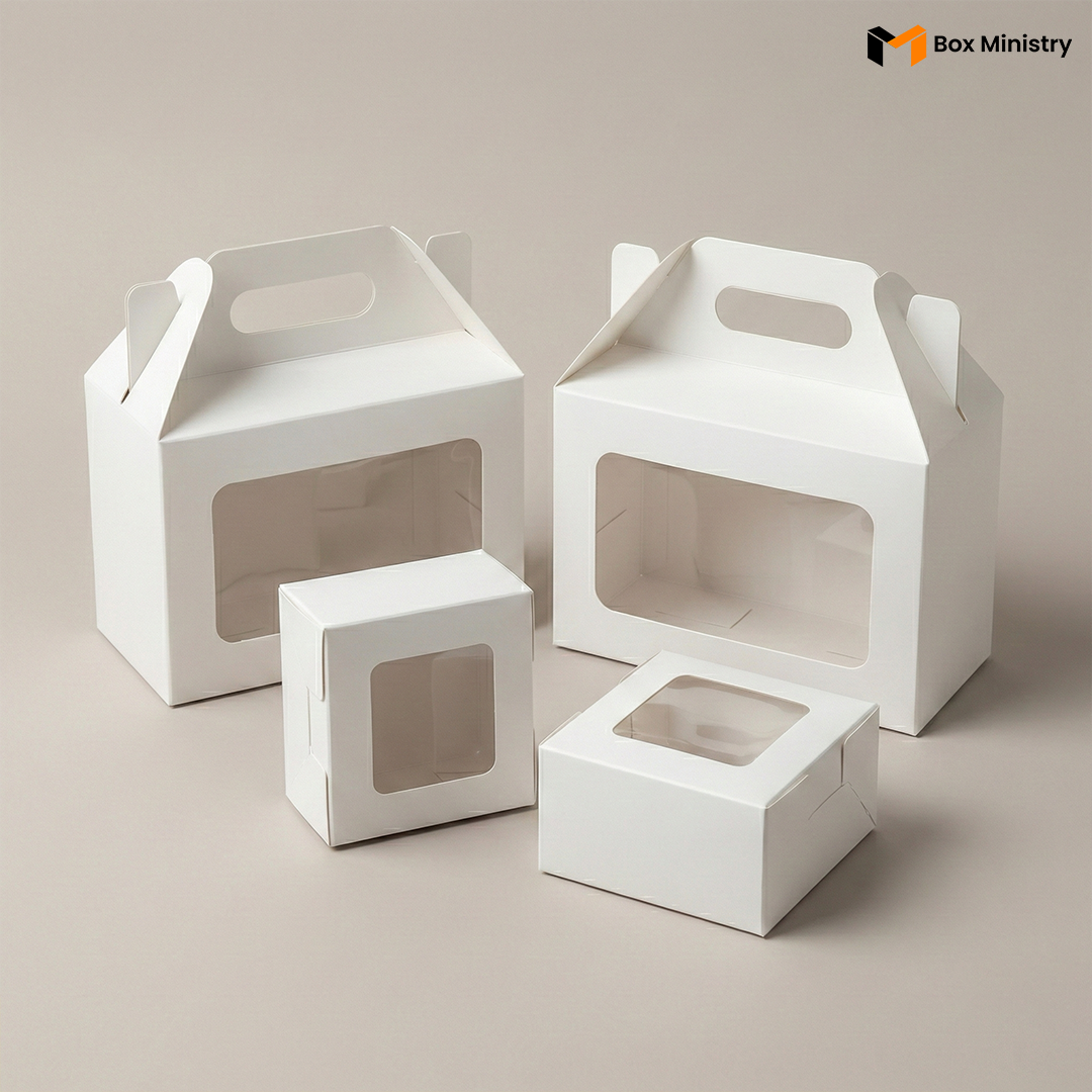 White cupcake boxes stacked and arranged in a group shot showing handle and no-handle styles